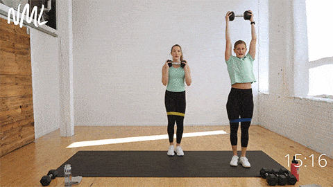 two women performing side step squat thrusters as part of core and glute workout