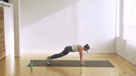 woman performing a plank to bear crawl and resistance band open