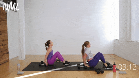 two women performing tricep dips on dumbbells in an arm and shoulder workout for women