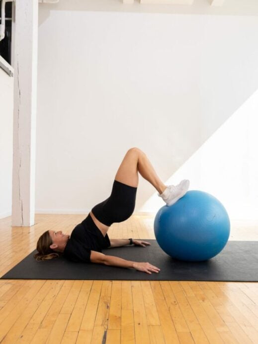 woman performing hamstring curls as part of hamstring workout at home