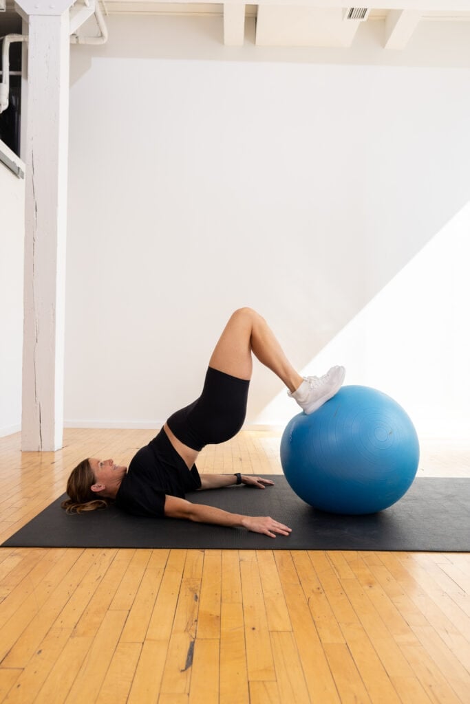 woman performing hamstring curls as part of hamstring workout at home