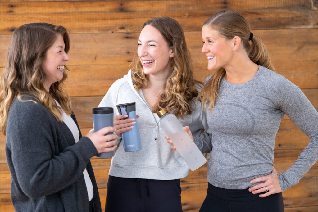 3 women laughing together while wearing lululemon