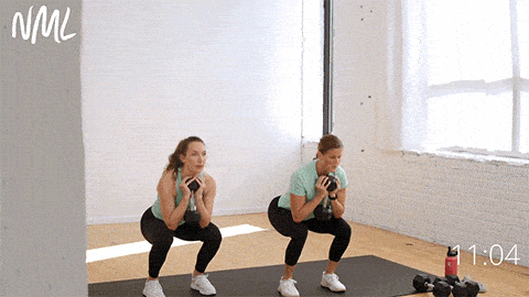 two women performing prisoner get ups as part of abs and glutes workout