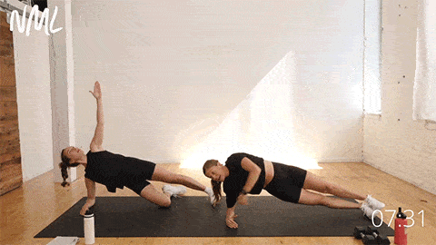 two women performing a side plank exercise