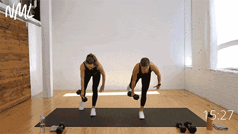 two women performing a single leg deadlift as part of standing core workout with weights