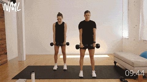 two women performing standard deadlifts as part of hamstring exercises workout