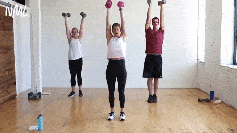 three people performing a 2-pulse squat thruster with dumbbells front racked in a circuit training workout