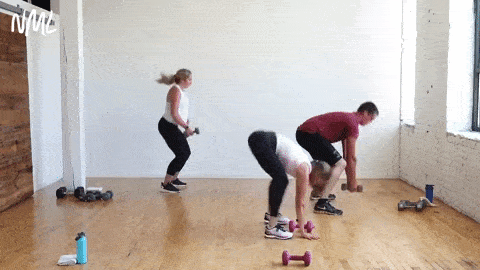 three people performing a burpee and dumbbell pick up in a circuit training workout