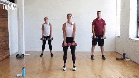 three people performing a dumbbell upright row and row to overhead shoulder press in a circuit training workout