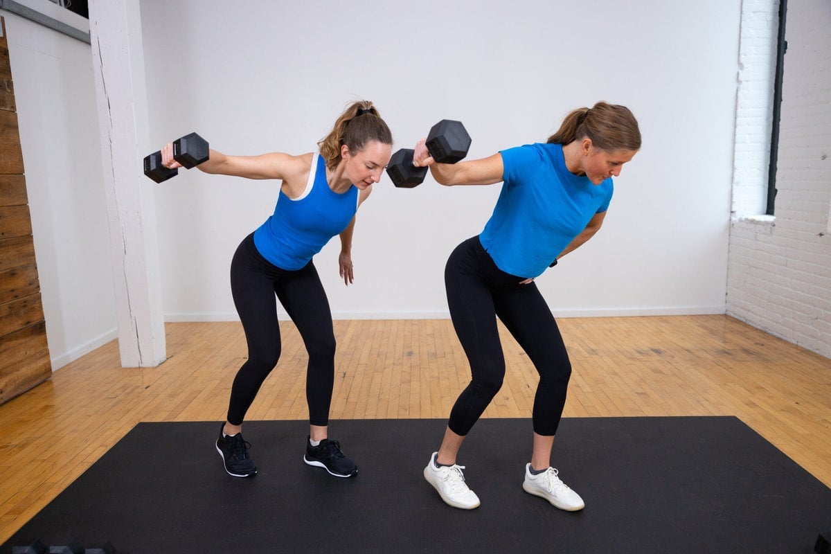 two women performing a single arm back fly as part of back and arm workout