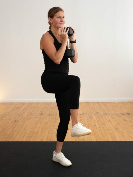 woman performing a goblet hold march in a core workout with weights