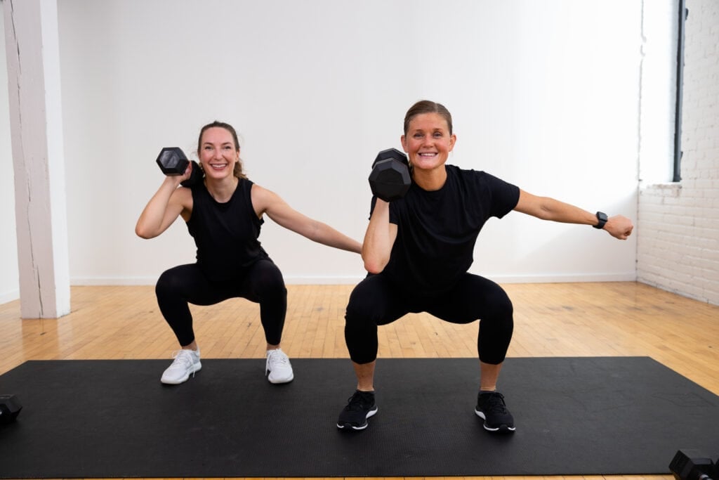 two women performing an uneven squat as part of functional training workout