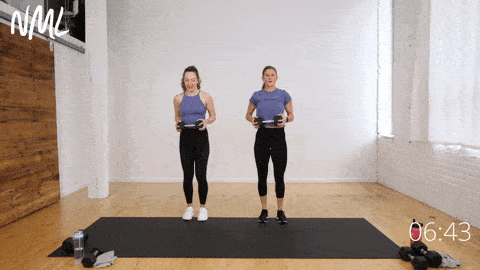 two women demonstrating a front lunge and spinal rotation as part of functional core training exercises
