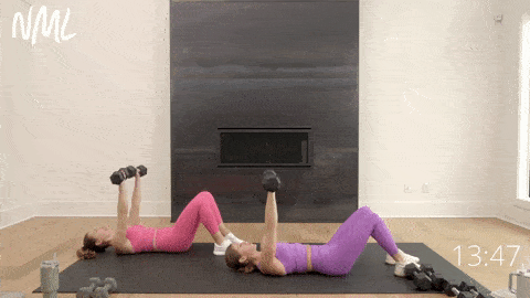 two women performing dumbbell chest presses as part of Toned Arms workout for women