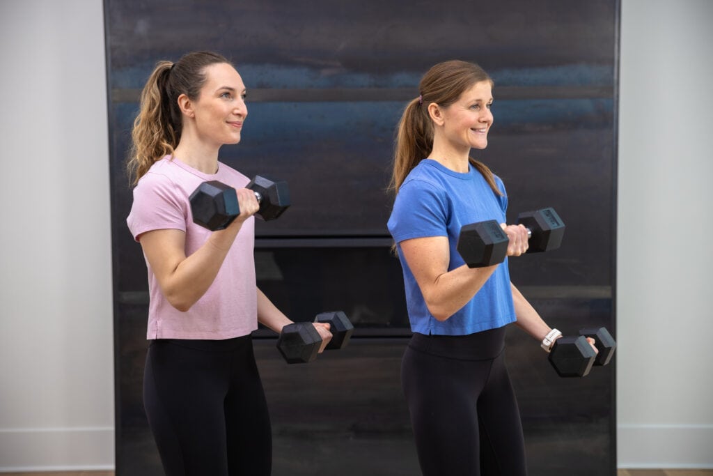 two women performing bicep curls as part of 14 day challenge