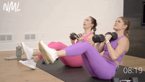 two women performing a v sit and shoulder press as part of Toned Arms Women workout