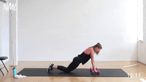 woman performing a slow push up into a fast push up in a HIIT workout at home