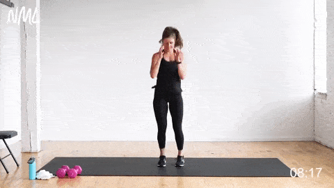 woman performing lunge jumps in a 30-minute HIIT workout at home