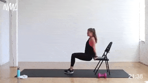 woman performing tricep dips in a HIIT workout at home