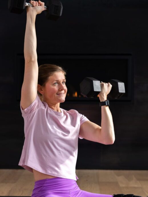 woman performing a seated shoulder press as example of floor exercise