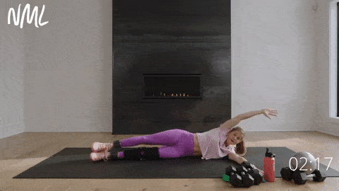 woman lying on her side performing a side leg lift and oblique crunch
