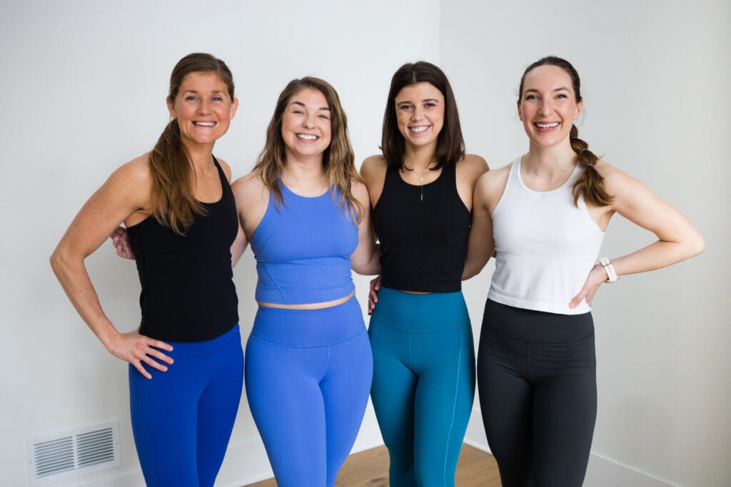four women posing in a photo wearing lululemon leggings and tanks as part of a review of the best lululemon Black Friday scores