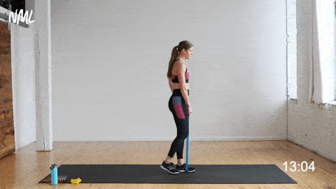 Women with a resistance band underneath the sole of her foot performing a hip hinge and reverse lunge in a lower body workout. 