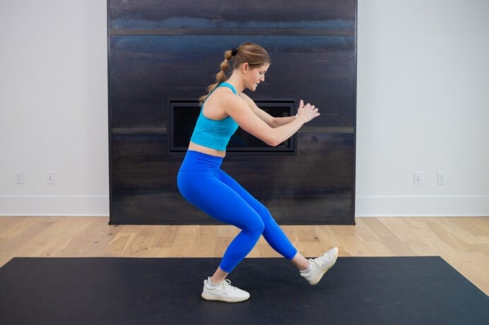 woman performing a knee strengthening exercise at home