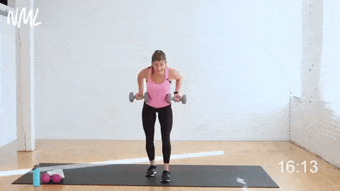 woman performing a reverse grip back row and hold and alternating arm lowers in a total body workout