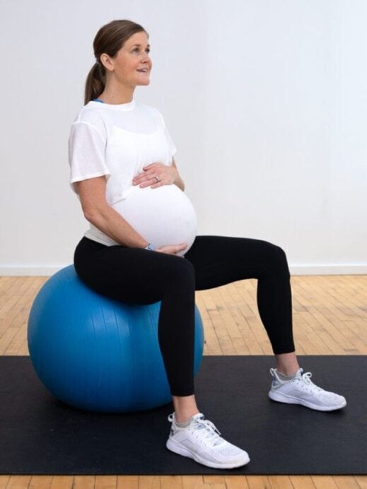 woman sitting on a birthing ball as part of best pregnancy ball exercises workout