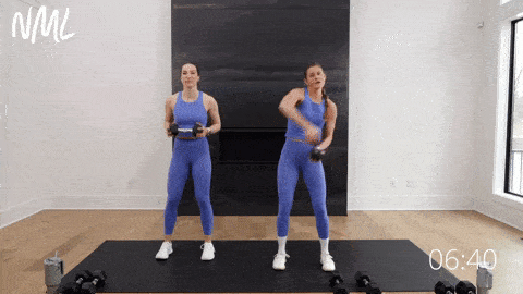 two women performing dumbbell halos to target shoulder muscles