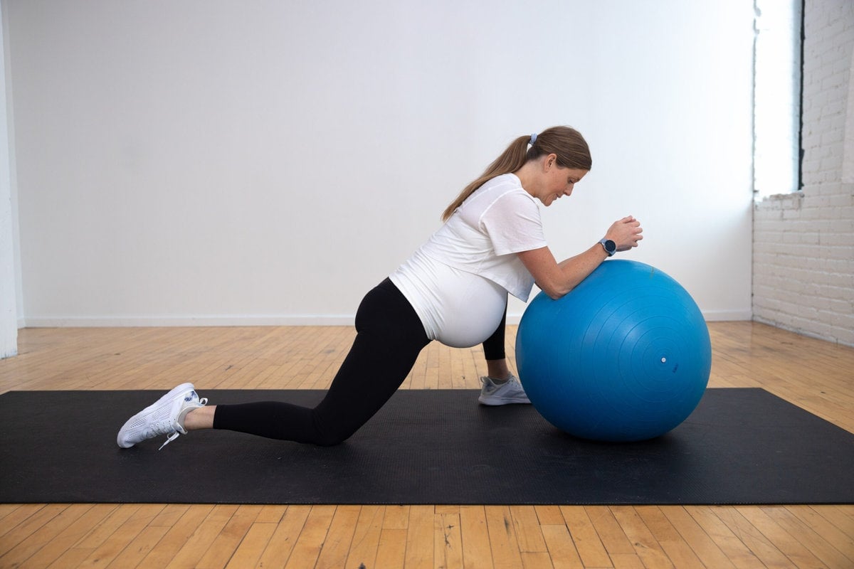 woman performing hip opener exercise as example of best pregnancy ball exercises