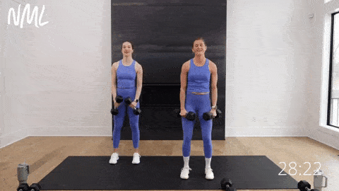 two women performing lateral raises as part of upper body hiit workout
