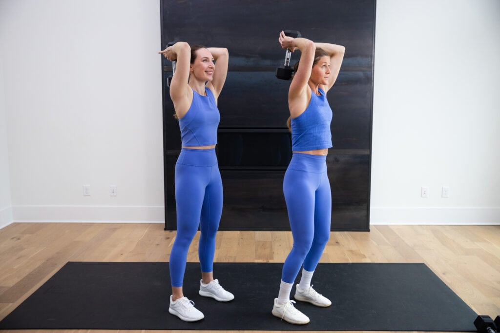 two women standing performing tricep extensions as example of upper body hiit exercise