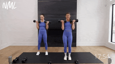 two women performing bicep curls as part of upper body hiit workout