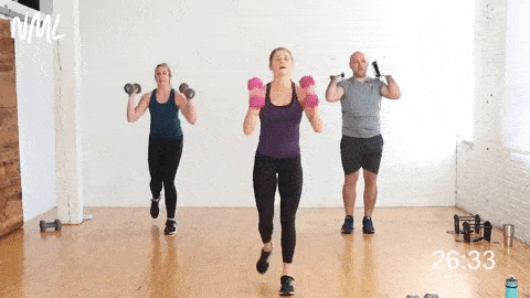 three people performing two pulse reverse lunge thrusters with dumbbells front racked