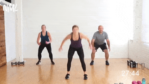 three people performing a double squat jump in a circuit workout at home