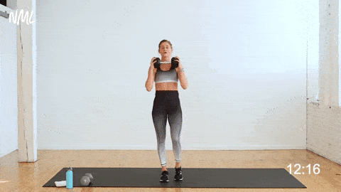 woman performing a reverse lunge with a calf raise as part of single dumbbell workout