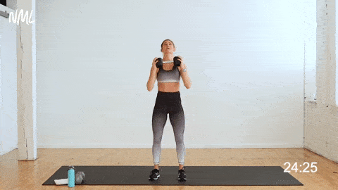 woman performing shoulder press and tricep extension exercise as part of one dumbbell workout