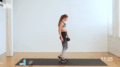 woman performing reverse lunge and staggered deadlift as part of one dumbbell workout