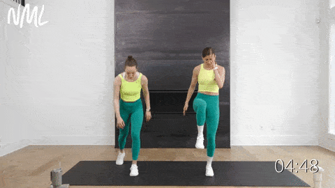 two women performing four high knees and a tap down in a standing cardio workout