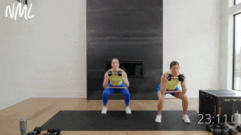 two women performing a banded lateral squat thruster in a full body push workout at home