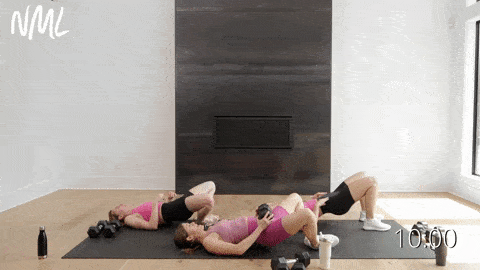 three women performing glute bridges in a dumbbell leg workout