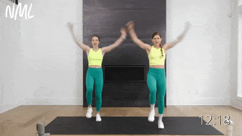 two women performing high knee jacks in a low impact standing cardio workout