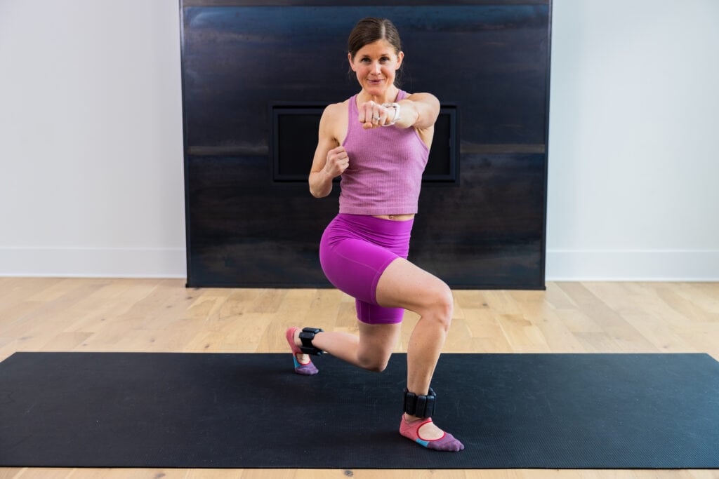 woman performing a lunge and crossbody crunch as part example of ankle weight exercises