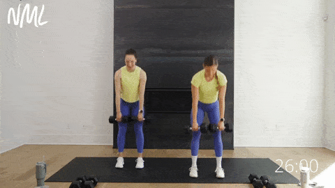 two women performing slow and controlled deadlifts as part of lower body dumbbell workout