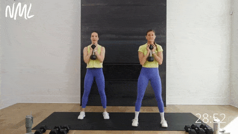 two women performing goblet squats as part of lower body workout with dumbbells