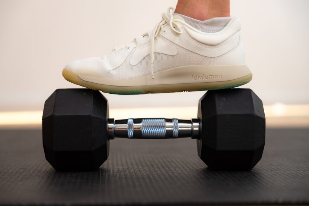 lululemon shoe balanced on top of a dumbbell