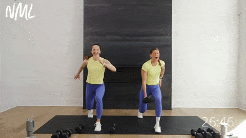 two women performing a low lunge with a calf raise as part of lower body dumbbell workout