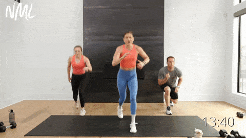 three people performing lunge drops on large black mat as part of cardio and strength workout